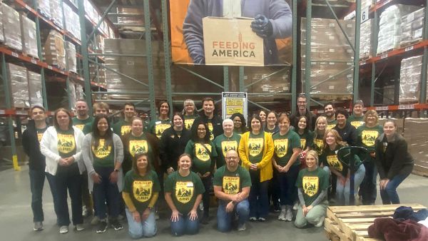 CBT employees grouped together smiling for a photo