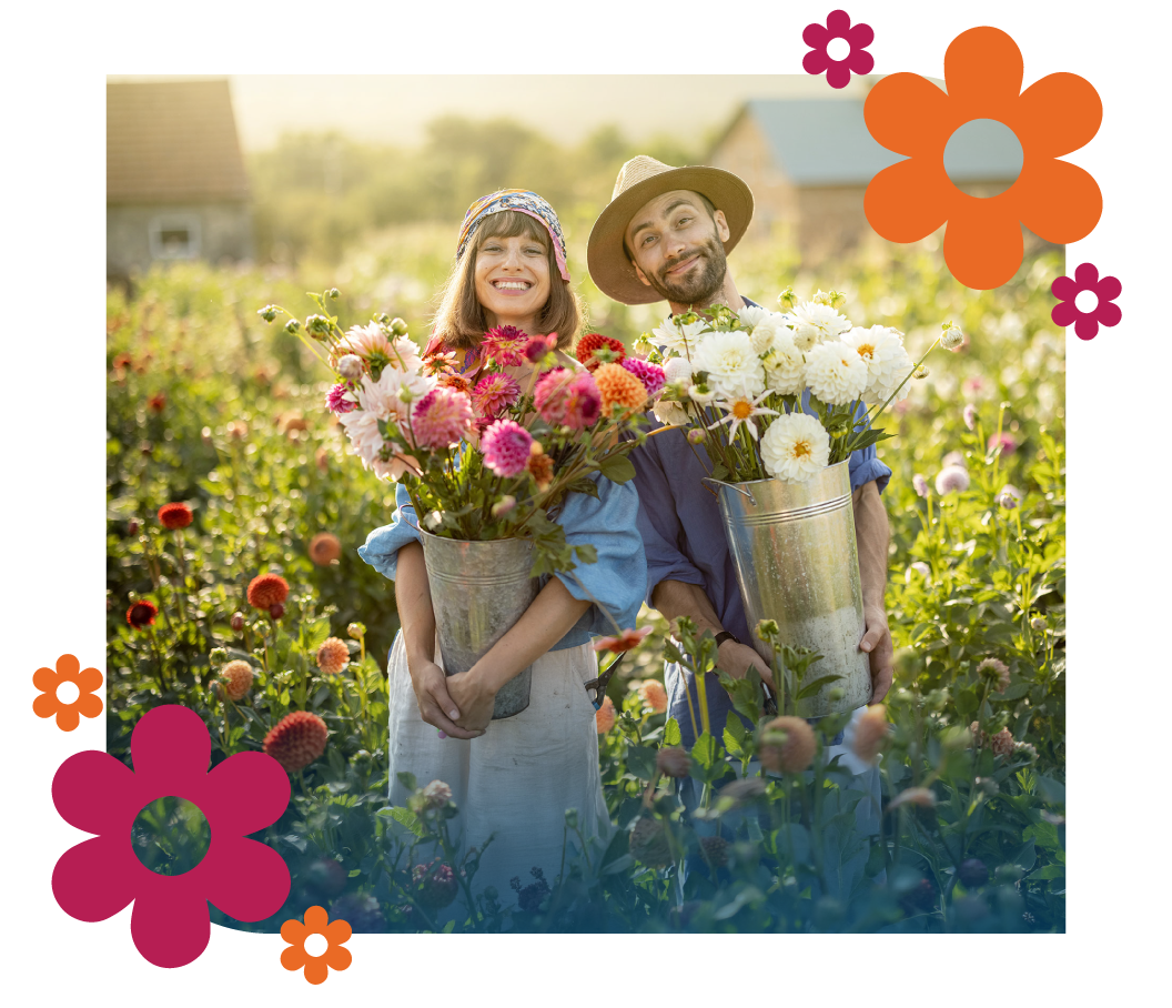 Couple holding bouquets in a flower field.